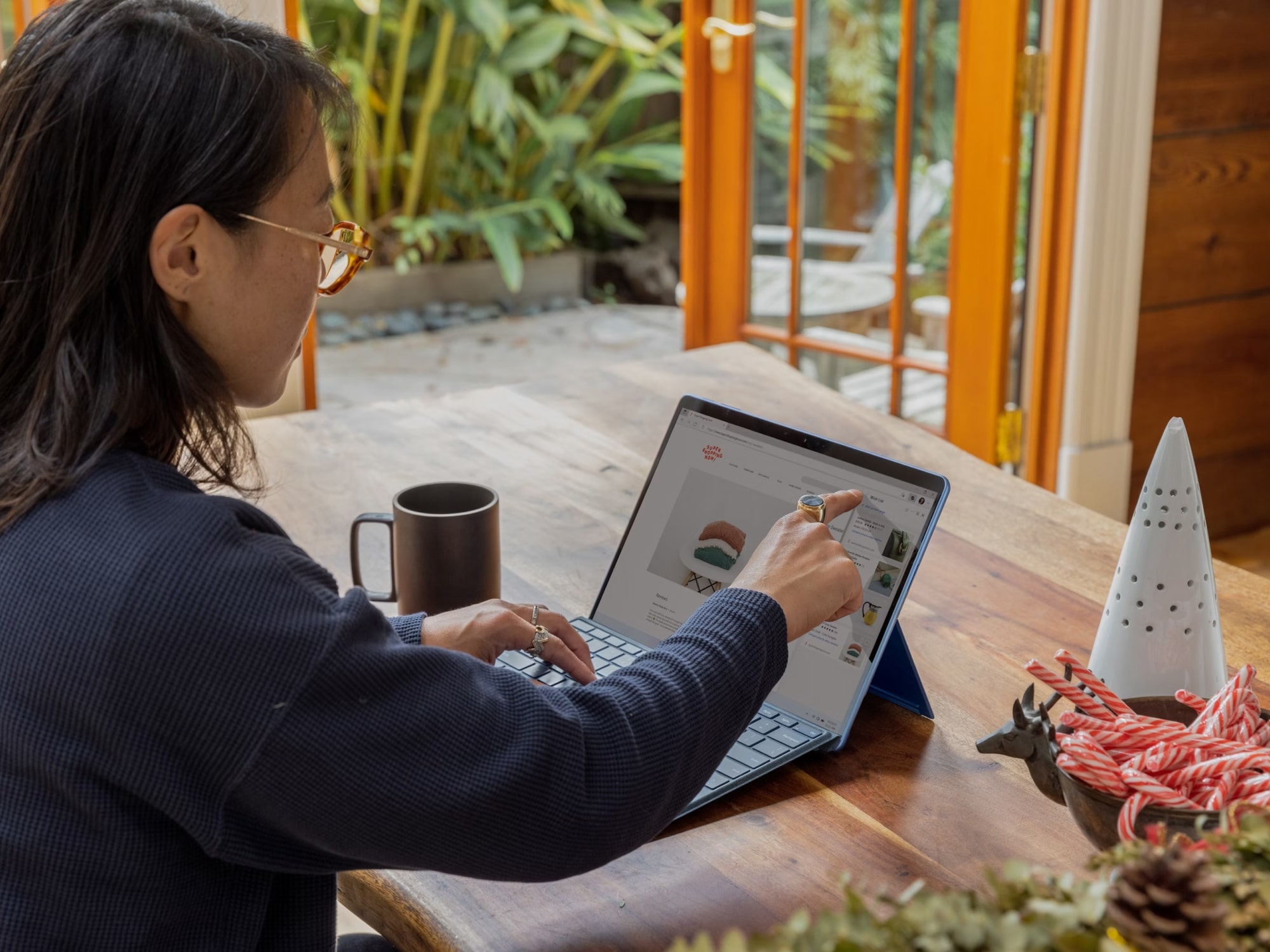 A professional woman working on a laptop in a cozy office environment